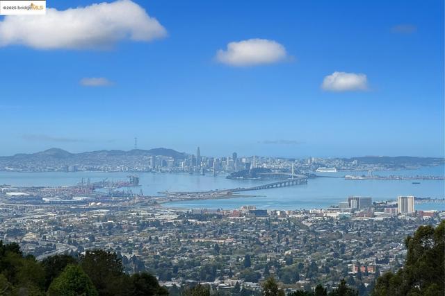 Water view featuring nearby urban area and a notable bridge