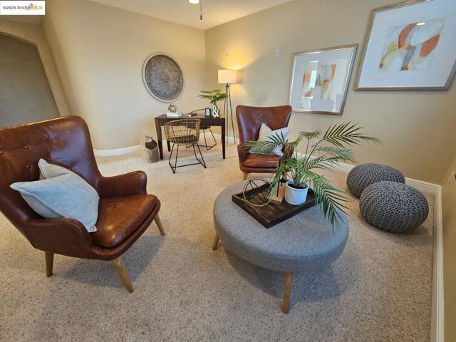 Sitting room featuring carpet floors and baseboards