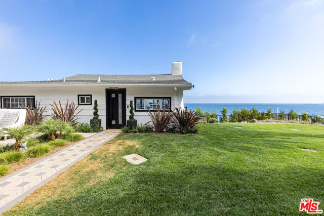 Soak up panoramic ocean views and endless natural light in this freshly updated Malibu oasis. Perched on the bluffs by Las Flores Beach, this privately gated single-level home features two bedrooms, a relaxed layout, recent upgrades, and a wraparound deck that invites you to luxuriate in serene seaside living. Pull up to a gated driveway with space for three cars. Enclosed behind the property's fence and grove of cypress trees, discover beautifully landscaped grounds where you can entertain. When you enter, ample natural light and new hardwood floors welcome you into a comfortable open-concept living area with a wood-burning fireplace, dining area, and bright, beachy kitchen. The Viking range and new fixtures will make future meal prep a delight. Floor-to-ceiling glass doors seamlessly extend the home's interior to the balcony - a perfect place to wake up and listen to the waves or watch the glistening lights of the Queen's Necklace. Take in more views from the comfort of your primary bedroom. Sleep soundly knowing that cameras surround the property. Additional highlights include freshly painted walls, brand new grates, LG thinQ IQ stackable washer and dryer, brand new custom window treatments throughout, brand new AC unit, and a new water heater. Pristinely situated, the home puts you within steps of sandy beaches, only moments from downtown Santa Monica, and just a few minutes from Malibu's famed amenities, including Nobu and the pier. Also available for LEASE for $20,000/month.