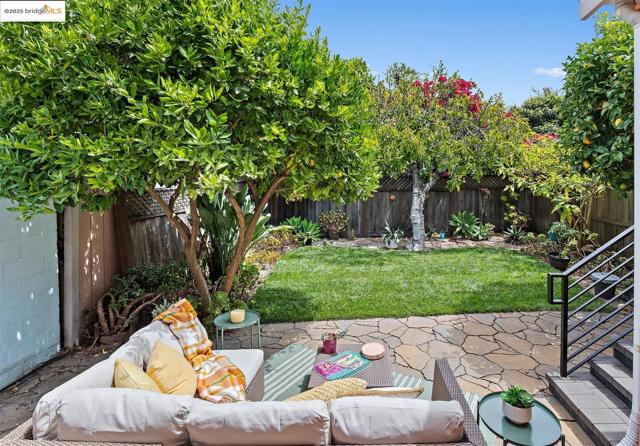 Fenced backyard featuring a patio area and stairs