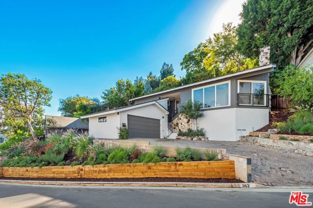 3624 Shannon Road Los Angeles, California Meticulously remodeled Mid-Century in one of the most sought-after areas of Los Feliz. This home was restored with care to maintain the beauty and integrity of this iconic neighborhood all while offering the amenities of a new home. Vaulted ceilings and striking stucco fireplace greet you immediately as you enter the spacious living room. An expansive chefs kitchen features stainless steel appliances, quartz countertops, custom cabinetry, and an abundance of natural light. The kitchen opens to a dining room along with a patio perfect for alfresco dining. Downstairs features an inviting, oversized guest room with its own fireplace. Upstairs the master suite has a sliding glass door that leads to a private yard. Two additional bedrooms and guest suite are located on this level. A beautiful, tiered yard offers privacy, stunning sunset views & your own herb garden, citrus trees & lovely drought tolerant landscaping. Some additional features include all new systems, hardwood floors & designer finishes. This home is perfect for families, entertainers & artists. Only moments from everything the city has to offer you will feel like you are living in your own private retreat.