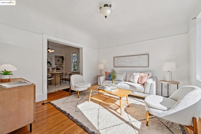 Living room featuring light wood-type flooring and baseboards