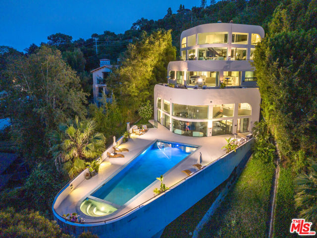 The 'Bel Air Yacht Mansion." Designed by world-renowned architect Glen Small. The private gated architectural, 26-room landmark was built on over 1/2 acre of land w/ incredible 300-degree jetliner views; perched perfectly on the Mulholland Corridor. This is the ideal entertainer's home!  Along with 5 beds/8 baths, this property boasts a theater, gym, office, wine/cigar room, clubroom, a billiards lounge, (2) kitchens (main and club level), formal living room, family room, and dining area that all lead to a service counter/wet bar.  All bedrooms are ensuite.  Primary bedroom has 2 separate bathrooms both with roman baths for relaxation & escape, huge walk-in closets & private balcony area.  There is about 2,500 sq ft of outdoor lounging decks w/2 separate hot tubs.  Club level has an incredible 46 ft. color-changing lap pool w/spa, full kitchen, huge gathering area, and (2) separate baths.  Other features include: eight-car private motor court, elevator and total privacy.  Former residence to several A-List celebrities and has been the backdrop in many film, video, & TV productions. Plus, it has also hosted Oscar & Grammy afterparties and has recently collected $500K for a 6 month rental. This modern masterpiece is searching for its next lucky owner to take it to the next level. Incredible value/sqft!! The property was appraised at $13.5M.  Appraisal report avail. upon request.