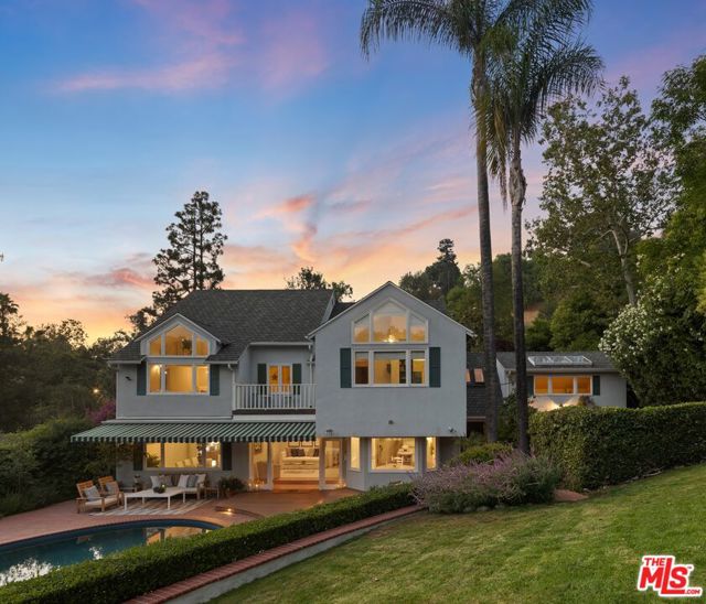 11818 Laurel Hills Road Studio City, California RARE OPPORTUNITY for one of the most coveted, private yet accessible locations in Studio City. Tucked away at the end of a secluded cul-de-sac, this upgraded celebrity Cape Cod Estate, behind gates, offers sophisticated family elegance boasting a massive park-like backyard, unobstructed vista views, just steps away from the famed Fryman Canyon trailhead and Charter Carpenter school. A huge open loft playroom with floor to ceiling windows framing unobstructed lush trees and mountains, and an oversized newly added guest house with a full bath and a private entrance from the street. This unparalleled breathtaking home has been featured in numerous magazines as it has the feel of a private compound in Santa Barbara yet still seconds to local hiking trails, studios and all the shops. Set on a sprawling 13,325 sq. ft. lot, this 4,148 sq. ft. residence features six bedrooms and four bathrooms thoughtfully designed to maximize space, comfort, and an abundance of natural light. The sunlit interior boasts a spacious open-concept living area, where a French stone hearth surrounds a wood-burning fireplace, creating a warm and inviting atmosphere. The chef's kitchen is equipped with top-of-the-line Viking commercial appliances, granite countertops, a Bosch dishwasher, a Viking wine cooler, and a separate pantry, all seamlessly flowing into a formal dining area. The spacious primary suite is a private sanctuary, featuring a second wood-burning fireplace, a full seating area and expansive Mountain View's as its the tallest house at the end of the cul-de-sac. Custom walk-in closets, and a spa-like bathroom with rare French stone flooring, a clawfoot soaking tub, a glass walk-in shower, and skylights that bathe the space in natural light. Additional highlights include an expansive dedicated office with skylights with a private entrance to the street, and a guest suite with its own balcony leaving it completely private and breathtaking views. French doors lead to a sprawling backyard, complete with a newly resurfaced pebble tech extra large, deep pool with built-in spa, diving board, custom-built redwood decks with integrated lighting, and a state-of-the-art Control4 surround sound system for a Hollywood Bowl type of experience. The lush, mature landscaping features citrus trees, lavender, and birch trees, enhancing the natural beauty of the setting making for a children's playground paradise. The separate guest house offers flexibility for extended family, guests, or rental income. The home's gated driveway leads to a two-car garage and open carport equipped with a Tesla supercharger. Additional thoughtful upgrades include all-new air ducts and insulation, dual Nest thermostats for zoned climate control, and a tankless water heater. Considered an extra safe fire-wise deemed community, the estate has access to deep discounts for fire insurance. Don't miss out on this tranquil paradise.
