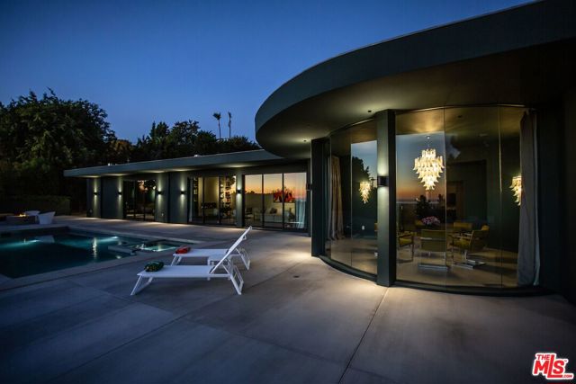 1715 Loma Vista Drive Beverly Hills, California Expansive city & ocean views from this stunning Trousdale Estates property. The renowned Hal Levitt performed the first major expansion & redesign of the home in '72 & it has just undergone another meticulous reimagining by designer Carter Bradley, resulting in a home of incredible quality & visual impact. A sophisticated environment that's both comfortable & elegant. The home comes furnished with a combination of custom & vintage pieces sourced from around the world. Spectacular light fixtures highlight the rooms; a coved-ceilinged entry hall, circular glass dining room, massive chef's kitchen & elegant oval living room. The spectacular master features a dressing room that is unequaled. Extremely private & expanded to nearly 5700 sq ft, the home has 10-foot ceilings, AV & security, custom window treatments, swimmers pool, entry courtyard with water feature, thoughtful landscape & energy efficiency. Designed to be easily maintained & enjoyed for years to come without becoming outdated.