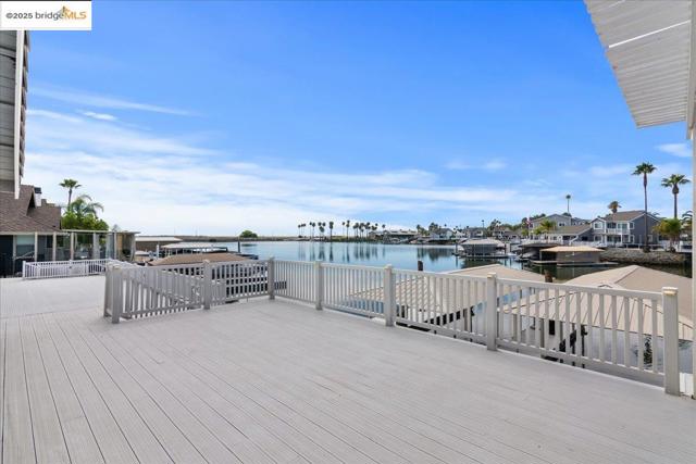 Wooden deck with a water view and a residential view