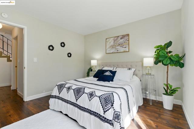 Bedroom featuring wood finished floors and baseboards