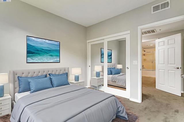 second bedroom with mirror closet doors