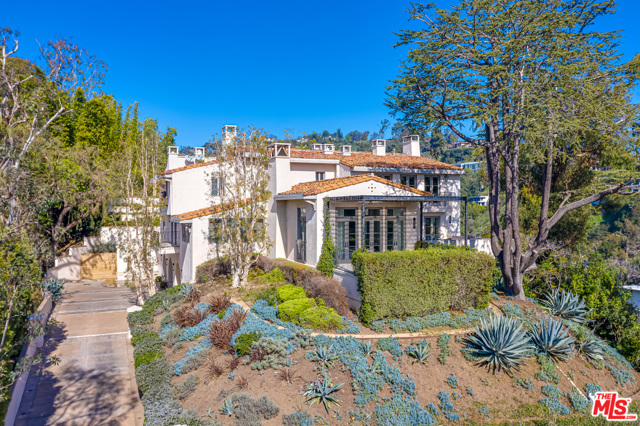 1235 Tower Road Beverly Hills, California Great Income property for potential 1031 Buyers. Ideally situated at the end of a cul-de-sac awaits this Contemporary Mediterranean Villa set behind gates with complete privacy and City & Ocean views. A large motor court and garage allow parking for 6+ cars. The entry is flooded with natural light and high ceilings that give a tremendous sense of volume. The large living room overlooks a grand entering balcony with city and ocean views. The twenty-plus person dining room is light and bright with large art walls and city views. The large gourmet kitchen has a restaurant-grade walk-in refrigerator and wine room. The backyard is surrounded by lush mature landscaping and offers absolute privacy.