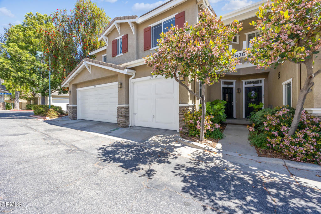 Welcome to 23636 Big Sky Walk #137, a beautifully maintained 2-bedroom, 2-bathroom townhome in the highly desirable Montana Townhomes subdivision of Valencia! This inviting two-story home offers comfort, style, and convenience in one of the area's most charming communities. Originally used as the model home for the community, it was thoughtfully designed to showcase the best of Montana Townhomes. Step inside to find new flooring and a freshly painted interior, creating a bright, welcoming atmosphere. The open-concept dining/living area features a gas fireplace with a stone surround and a built-in niche for your TV and entertainment equipment, as well as a large patio door that fills the space with natural light and opens to a peaceful private patio--perfect for morning coffee, gardening, or relaxing under the shade of a mature tree. The kitchen includes granite countertops, a quaint breakfast bar, ample cabinetry with a pantry, and a functional layout ideal for everyday living or entertaining. Upstairs, you'll find two bedrooms and two full bathrooms, including a charming primary suite with plantation shutters, an en suite bath, and beautiful views of trees and the pool. The secondary bedroom is light-filled and versatile, perfect for guests, kids, or a home office. Enjoy the beautifully landscaped community grounds, with mature trees, lush greenery, and a sparkling pool and spa just steps from your front door. Ideally located near Bridgeport Marketplace, dining, entertainment, paseo trails, local parks, and top-rated schools. The neighborhood also hosts regular events that create a welcoming sense of community. This home also features a 1-car attached garage with extensive storage, a reserved parking space just steps away, and convenient guest parking throughout the community--all with a low HOA and no Mello Roos. Don't miss your chance to own this charming home in one of Valencia's most sought-after neighborhoods!
