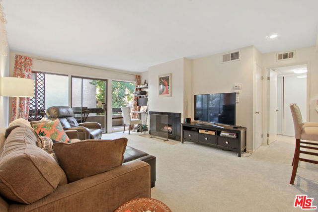 Living room with gas fireplace and balcony