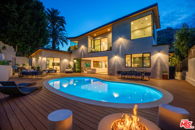 2220 Coldwater Canyon Drive Beverly Hills, California Magnificent newly completed architectural home with great volume and scale. Stunning ultra-luxurious, high-end finishes. Featuring wide plank European oak floors, a porcelain clad media wall and sleek fireplace. Retractable doors invite the outdoors inside. Gorgeous open kitchen with top-of-the-line appliances and dreamy marble counters. There are two bedroom suites on the main level, one of which can be used as a second primary bedroom. Upstairs features a sumptuous grand suite with dual closets and stunning bathroom with porcelain flooring and marble counters. In addition, there is another bedroom suite with lovely canyon views. Magnificent outdoor area with sparkling pool, outdoor kitchen, fire pit and terraced gardens. Gated, with circular driveway and 2-car garage. Sensational living in the Hills!