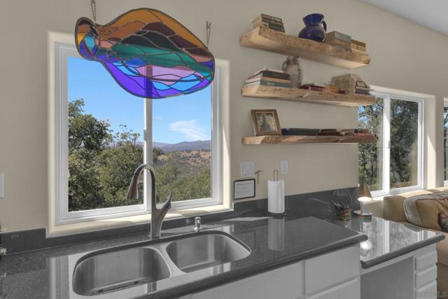 The sink with a view! The double stainless-steel sink sits at a window with views of the Volcan Mountain range.