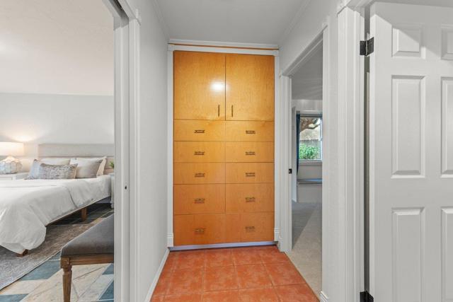 End of hallway storage cabinets for linens, and motion sense light in the hallway
