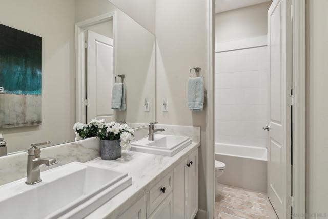 Secondary bedrooms have the convenience of this bathroom. Marble counters, dual sinks, private with door separating the toilet/shower and sink area.