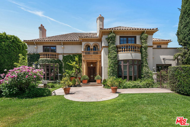 159 S Hudson Place Los Angeles, California Located on the coveted Hudson Ave, this Mediterranean estate boasts elegance, character, & grand scale. Sitting on an expansive corner lot, the home showcases a custom facade surrounded by lush gardens and mature landscaping providing the utmost privacy. Enter into the grand foyer with a sweeping staircase, wood inlay floors, custom crown molding & french doors. Featuring 6 bedrooms and 8 bathrooms, the home boasts over 8,500sf of quintessential living spaces w/ designer details including custom millwork, ornate crown molding, imported fixtures, & French doors opening up to balconies, verandas, and entertaining areas. Perfect for relaxation and entertainment, the backyard hosts a wraparound grassy yard, large swimmers pool, a spa, various patios, and outdoor dining area.