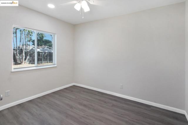 Bedroom featuring dark wood-style floors, a ceiling fan, and recessed lighting