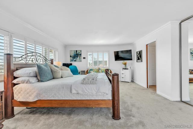 Oversized primary bedroom with Bay views and direct access to rear deck.