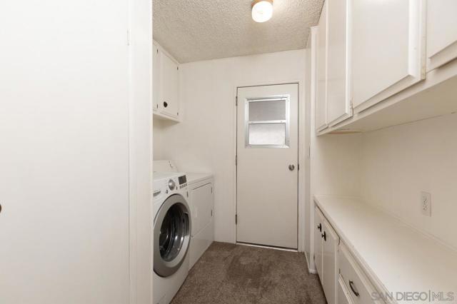 Laundry room with washer & dryer included, lots of storage, and entry door to carport!