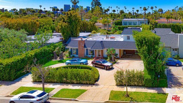 FAMOUSLY LOCATED IN THE BEVERLY HILLS FLAT W/ EQUALLY FAMOUS ZIPCODE 90210.  THIS INCREDIBLE DREAM HOME IN THE HEART OF THE BEVERLY HILLS HAS IT ALL !!. THIS TRADITIONAL HOME IS A MUST SEE:  FEATURE CENTER HALL FLOOR PLAN W/ 6BR & 6BA ON TWO SEPARATE PROPERTIES ON AN OVER-SIZE LOT NEARLY 14,000 SF; MAIN-HOUSE HAS 3 BEDROOMS, 3 BATHROOMS DOWNSTAIRS AND 2 EN-SUITE BEDROOMS UPSTAIRS. THE ESTATE FEATURES A SPACIOUS LIVING ROOM W/ GRAND FIREPLACE, FORMAL DINING ROOM W/ GORGEOU CHANDELIER, SPACIOUS KITCHEN, COZY CARD ROOM / BAR ROOM AND LARGE FAMILY RM LEADING TO A BEAUTIFULLY & PRIVATE LANDSCAPED VERDANT BACKYARD; THIS HOME WOULD NOT BE COMPLETE WITHOUT A BEAUTIFULLY DESIGNED SHAPE SWIMMING POOL, BARBECUE/OUTDOOR DINING AREA; THE CHARMING & SEPARATE POOL/GUEST HOUSE FEATURES EXPOSED-BEAM & VALTED CEILING AND AN INVITING STONE-FACE FIRE-PLACE WITH ONE BATH THAT WOULD TRANSPORT YOU AND GIVE YOU A FEEL OF WOODEN CABIN;  MAIN HOUSE HAS RARE PEG & GROOVE HARDWOOD FLOORS, CARPET, AND TILE FLOORING THROUGHOUT; THIS ESTATE FEATURES A GRAND CIRCULAR DRIVEWAY INCLUDING PARKING FOR 7+ CARS; IT IS PRACTICALLY STONE-THOW AWAY FROM THE DESIRABLE HAWTHORNE ELEMENTARY SCHOOL. PRIME LOCATION WITH PROXIMITY TO THE GOLDEN TRIANGLE FEATURING WORLD CLASS DINING; BRAND NAMES BOUTIQUES, BEVERLY HILLS CITY HALL & CENTRAL LIBRARY & POLICE STATION; FAMOUS BEVERLY HILLS LANDMARKS, FAME SHOPS, RENOUNCED FINANCIAL INSTITUTIONS, AMONG THE BEST SCHOOL DISTRICT IN THE COUNTRY. AND MUCH MORE..!  MOST UNIQUELY AND TRULLY ONE OF KIND, THIS WAS THE FORMER RESIDENCE OF "MARY MARTIN" - THE FAMOUS ACTRESS, SINGER, AND STAR OF THE MOTION PICTURE "PETER PAN".  WELCOME YOU HOME TO THIS CHARMING ESTATE !!!  WON'T LAST !!  ** GUEST HOUSE IS NON-PERMIT & ITS SF IS INCLUDED IN TOTAL HOUSE SF **