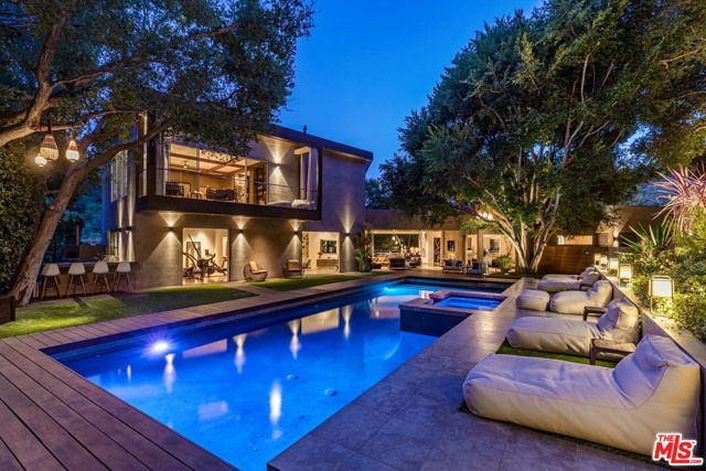 11011 ANZIO Road Los Angeles, California Bel Air Oasis. Complete Privacy up a long gated driveway, warm modern retreat surrounded by lush greenery. Renovated to exacting standards by current owner, walls of glass open to large 50ft pool and outdoor entertaining spaces. A loft like great room for living/dining, gourmet kitchen and intimate den all set the stage for a glamorous lifestyle. Upstairs master suite is the ultimate hideaway with beautiful terrace, large closet/dressing room, marble bath with infrared sauna and steam shower. 5 additional bedrooms perfect for guests, one being used as a gym. Sense of calm and serenity throughout. Complete Crestron automation. Additional features include: full outdoor kitchen with pizza oven, meditation garden, walking paths, off street parking for 4 cars.