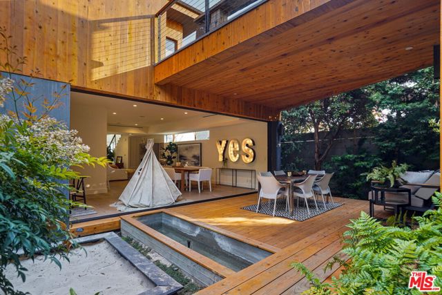 561 Brooks Avenue Venice, California A quintessential California escape, this light-filled 4 Bed/4.5+ bath contemporary home boasts an indoor-outdoor floor plan, sophisticated Bohemian decor, spacious sundeck & private roof-deck w/ panoramic views. You are welcomed by verdant hedges & a covered patio leading to the sun-soaked living room w/ full-height windows & built-in fireplace. Cooking is a treat in the gorgeous chefs kitchen w/ Viking appliances & large breakfast bar. Pocket doors span the entire rear wall opening to a courtyard framed by lush foliage. Upstairs, a bright hallway opens to the picturesque sundeck. The plush master suite features an en suite bathroom w/ dual sinks separate tub & shower. Stargaze & admire sweeping landscapes from the private master bed roof-deck. Stroll across the sun drenched bridge deck to enter the incredible entertainment room equipped with wet-bar and bath (This could easily be divided up to use as office and entertainment). To top it off downstairs boasts a beautifully finished garage that acts as a 2nd master suite (Finished garage not included in interior sf / Considered 4th bed/4th Full Bath). This home is truly a Venice Gem, don't miss out! Incredible west of Lincoln location within walking distance to Abbot Kinney or Venice Beach.