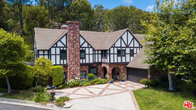 17750 CAMINO DE YATASTO Pacific Palisades, California Located in the desirable, 24-hour guard gated, Highlands neighborhood of the Country Estates. Come see this beautiful English Tudor style home, on the market for the first time in 41 years, with features only found in a vintage home like this. It offers open beamed ceilings, hardwood floors, and a distinct pitched roofline. This property provides the new owners the opportunity to restore this lovely classic home back to its pristine glory or modernize the estate to create a home with a traditional Tudor style exterior and modern interior. This gorgeous 4,012 square foot home offers 4 bedrooms upstairs, two offices downstairs, 4 baths and an amazing outside space that lends itself to a spectacular entertaining area. Just over 2 acres, this landscaped, amphitheater-like lot is dressed with an abundance of large mature trees, providing not only privacy, but also natural beauty. Enjoy the very large pool with fountain, spa, built in BBQ & two large decks for sunbathing.