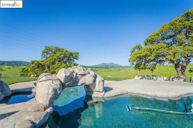2901 Briones Valley Rd Brentwood, California This beautiful ranch home has a private electric gated entrance, olive tree lined driveway and horse paddocks. 17.8 Acres with spectacular views from this hilltop home! Minutes to town off John Muir Parkway to Concord Ave. 208X100 Steel covered arena, over 20,000 sf area for horses or store your toys. Workshop and tack room with laminate floors. Owned S13Kv solar. Vaulted ceilings and open floor plan and breathtaking views from every window. Meticulously maintained w/ neutral carpets and large tile traffic areas including the family room and kitchen. The kitchen has beautiful granite counters, 5 burner gas cook top and upgraded stainless steel appliances. Master Suite is large with spa like bathroom with beautiful cabinets and garden tub. Perfect for entertaining with the large kitchen overlooking the family room. In ground pool with amazing design, large oak trees are the perfect setting with natural look with it's large boulders and you will feel like you are on vacation everyday!