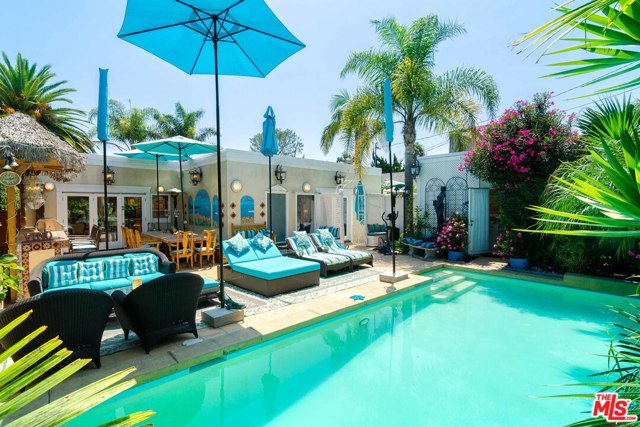 16857 W Sunset Boulevard Pacific Palisades, California This retreat-like home is located just minutes from the Palisades Village and a short stroll to the beach. The residence features an open plan with an oversized living room, family room, dining area, and many architectural details throughout. Other interior features include floor-to-ceiling, double-paned windows, skylights, two fireplaces, hardwood floors, a wine cellar, and a surround sound system. The custom kitchen features granite countertops, a center island, Viking appliances, a cocktail bar, and triple French doors leading to the amazing patio. A resort-like backyard with a swimming pool, waterfall, hand-painted murals, built-in Tiki bar, BBQ, and fireplace grace the yard, as well as a garage converted into a guest house. A potential 2nd story would likely capture ocean views. Don't miss this opportunity to move right in or update to an even more incredible dream home.