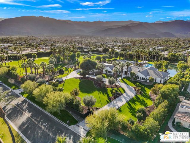 One-of-a-kind trophy estate at Rancho Mirage offering elegant proportions and grand scale living on nearly 8.5 park-like acres. Newly and meticulously remodeled to perfection, this rare-to-market opportunity features manicured grounds, private lake with boat launch, approach-style golf, lighted tennis court, and equestrian riding arena. Gated circular drive leads to the formal entry and motor court. Artful lighting and modernist design play beautifully together in this world class setting. Lustrous wood floors complement the natural palette and retracting glass walls. This 10,344 square foot "smart" home features seven bedroom suites, each with zoned HVAC. New pool and pavilion takes center stage with a series of conversation areas and fire pits. San Jacinto and Santa Rosa mountain views work their magic. Formal living and dining rooms enjoy sensational indoor-outdoor flow. Bar + screening room, glass enclosed wine room, library, and the element of surprise are a delight all throughout. Gourmet kitchen enjoys flawless finishes, professional grade appliances, prep kitchen, and butler's pantry. A service entrance leads to staff quarters. Two primary retreats offer kitchenettes, palatial baths, and direct patio access. Four car garage and ample guest parking. The property is home to a privately owned well to support the lake and irrigation system. Take the Matterport Virtual Tour for a better sense of 40315 Cholla Lane. Opportunity knocks, the time is now!