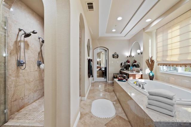 Primary Bathroom features dual sinks, large walk in shower, soaking tub, vanity and dual walk in closets.