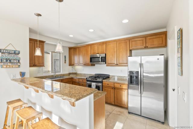 Granite counters, stainless interiors, and seamless flow to the dining area feel effortlessly curated.