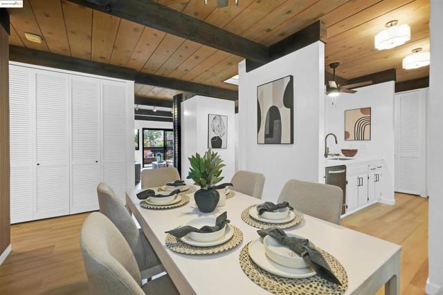 Dining area featuring a wood ceiling with exposed beams and light wood-style floors