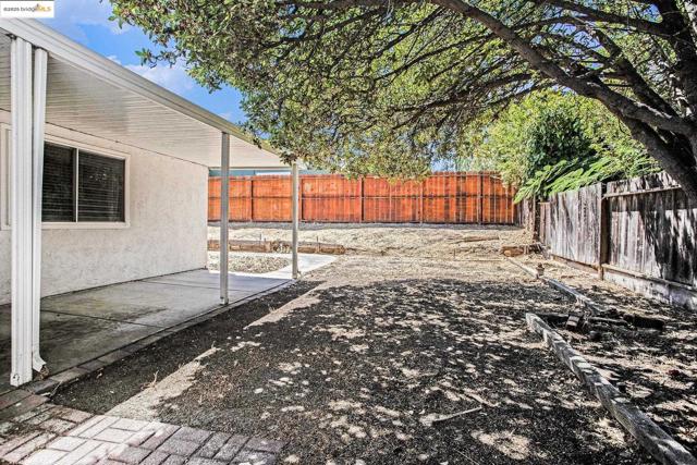 Fenced backyard featuring a patio