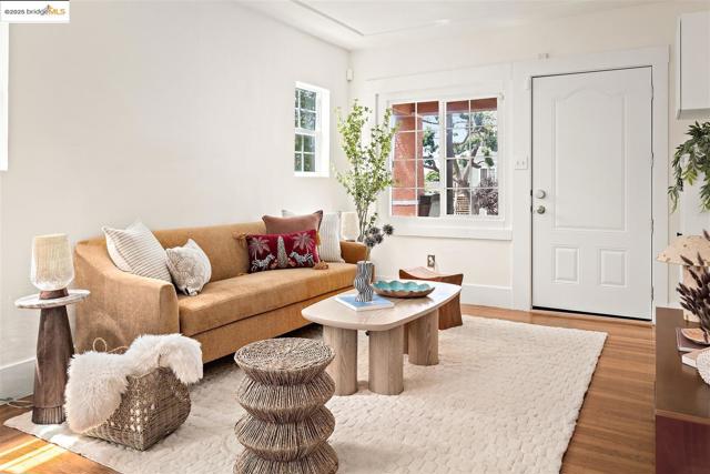 Living room featuring light wood-style floors and baseboards