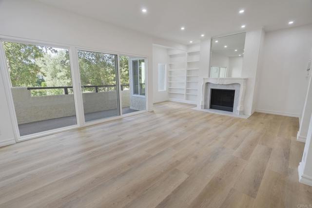 LR Balcony to Western Skies & Ocean Breezes.  Recessed Light-Built In's-LVP-SPC Flooring. Gas Fire!