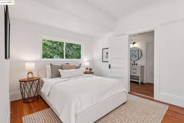 Bedroom featuring wood finished floors and ensuite bath