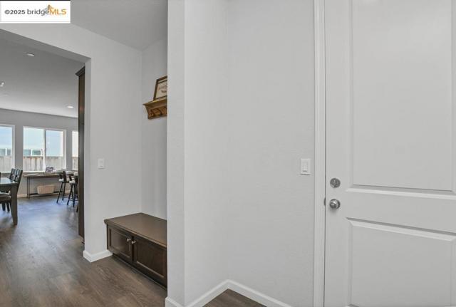 Hall featuring baseboards and dark wood finished floors