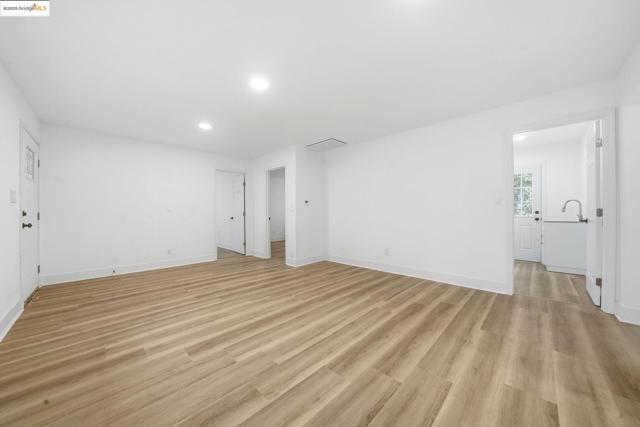 Unfurnished living room featuring light wood-style floors and recessed lighting