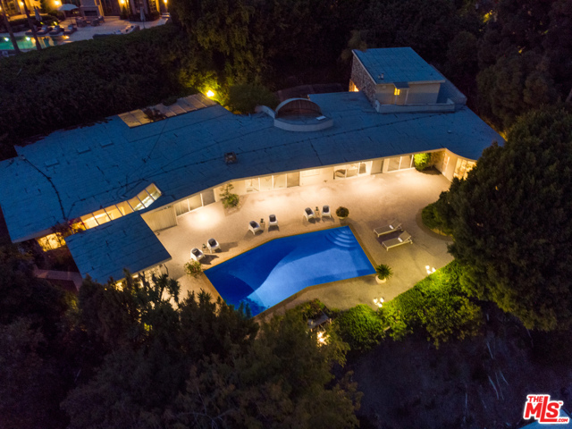 1111 Shadow Hill Way Beverly Hills, California Available for the first time in over 55 years, the former estate of Mel Torme & Zeppo Marx is one of the best opportunities on the market today. This single level home situated on a knoll with an expansive lot creates the perfect canvas for any owner or investor. Greeted by high ceilings & classic terrazzo floors, the interior is flooded by an abundance of natural light. From the massive motor court to the incredible view of the Century City skyline, this property provides an opportunity to beautifully reimagine or completely rebuild a dream home in the most desirable area of Beverly Hills. Mature landscaping makes this property ideal for anyone seeking a zen-like oasis rich in privacy. The lovely pool and detached pool house complete the exquisite grounds. Perched above the Beverly Hills Hotel and just minutes from the finest dining, leisure, and entertainment Beverly Hills has to offer, this home's location meets all the expectations of a luxurious lifestyle.