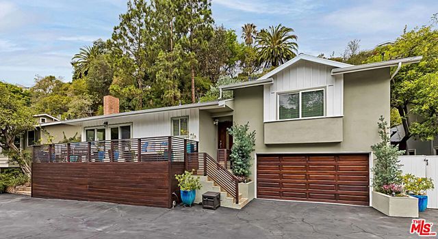 14517 W Sunset Boulevard Pacific Palisades, California This tastefully updated three-bedroom, two-bathroom home is set on a highly desirable alcove off of Sunset Boulevard. Just down the street from the famed Palisades Village, guests enter via an unassuming elevated private driveway to find this tranquil canyon home with abundant outdoor entertaining space and a relaxing and intimate interior. Through the front door, find a spacious open floor plan including a family room with fireplace, dining area, dining/lounging terrace, and large kitchen with an island, breakfast bar, and abundant counter space. A bedroom and bathroom complete the lower level. Up the minimal stairs are two bedrooms, including the primary suite with large walk-in closet, full bathroom, and direct access to the lush backyards upper deck. The secondary bedroom is utilized as a large office, but doubles as a bedroom. Accessed via multiple doors, the backyard is the ultimate entertaining space with seating for up to 25, a lounge with TV, and spa - all framed by a hillside of lush greenery. The offering is completed by a two-car garage, three additional driveway spaces, abundant storage and updates such as new floors, lighting, bathrooms, HVAC, roof, fireplace, built-ins, and more. Just moments from the beach, parks, hiking trails, and the Village, this is a rare opportunity that won't last long.