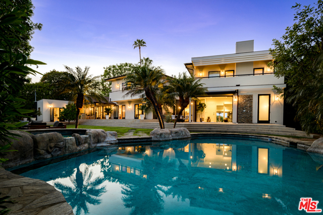 1201 Villa Woods Drive Pacific Palisades, California Escape the hustle and bustle to your own private and secluded estate, just minutes from the Village, in the famed Will Rogers area. Fully renovated in 2020, this bespoke contemporary two-story home spans over 4,750 SQ FT on an over 16,500 SQ FT lot and truly has it all. You are immediately greeted by the impressive frontage of the lot, only to be captured by the mid-century feeling of the living room that opens up to your park-like backyard - perfect for entertaining. The private yard features a calming lagoon pool and spa, outdoor dining area, fire pit, barbecue and private gym. On the main level you will also find the custom kitchen with top-of-the-line appliances and a breakfast nook, formal dining room, laundry room and two large en-suite bedrooms (one with its own private access) as well as the garage and a second entrance. Upstairs, you will find the master suite as well as a large second en suite bedroom. The master suite features its own private stairway down to the first floor as well as 2 walk-in closets, fireplace and large balcony overlooking the yard. Designed by up-and-coming Mimi Shin Design + Interiors and executed by the precise and exact Root Construction, no stone was left unturned at this better-than-new-construction home.