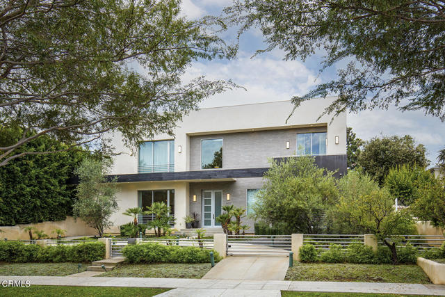 613 N Elm Drive Beverly Hills, California Situated on one of the most coveted streets in the Flats, this newly constructed, amazing contemporary style home is both a comfortable residence and welcoming retreat. Through the gated front garden, glass double doors open to light-filled, exceptional living spaces with sleek, modern, and clean line finishes throughout. A dramatic double-height foyer features modern pendant lights and gleaming tiled floors. Left of entry is the gracious formal dining room with a butler's pantry that flows to the sleek chef's kitchen, which features a large island, Wolf, Miele and Sub-Zero appliances, high gloss cabinetry, tons of prep space, a casual dining area, and an adjoining second kitchen offers convenience for outdoor cooking. The expansive great room boasts two seating areas, walls of glass, beautiful wood floors, a fireplace, and glass doors that open to a full length covered patio, lushly landscaped backyard and a sparkling pool, allowing for seamless indoor-outdoor entertaining. There is an en-suite bedroom and a maid's quarters on the first floor. A powder room and a laundry room complete the main floor. Upstairs, three en-suite bedrooms and an office surround a spacious sitting area. The grand primary suite contains a large sleeping room with a fireplace, sitting area, and access to a sundeck; an expansive dressing room with dual walk-in closets; and a lavish bathroom that includes a large glass shower, a soaking tub, two toilet rooms, double vanities, and a fireplace. Two additional large guest en-suite bedrooms and an office, each with glass doors, lead to a sundeck with spectacular tree top views. Additional features include a gated driveway with a Porte Cochere, detached two-car garage with alley access, electric car charger, 4-zone HVAC, and security alarm system.Located in the heart of Beverly Hills, just minutes from the trendiest shops, restaurants, and entertainment, this is modern living at its best!