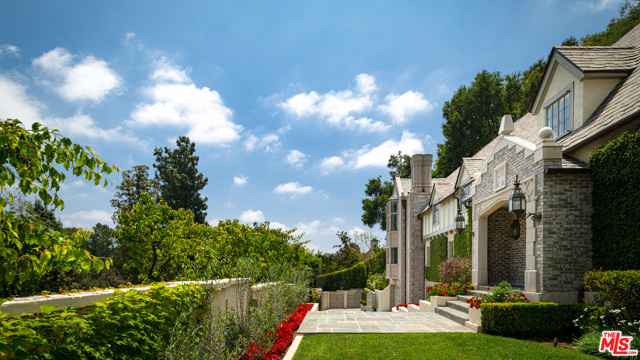 10950 Bellagio Road Los Angeles, California Prominently located in prestigious Lower Bel Air Estates sits this gorgeous English Manor on a generous acre lot privately gated & perched above the fairway of one of the world's most exclusive country clubs. Surrounded by pristine landscaping, soaring trees & dead-on golf course views, this elegant estate is bound to steal your heart. A gated entry greets you to the sweeping motor court for your most prized car collection. Entertain in the formal living room w/voluminous vaulted ceilings, opulent fireplace & oversized windows allowing for floods of natural light. A chef's dream, the kitchen is equipped w/La Cornue range, eat-in island, extensive cabinetry, elegant tile details & opens to the bright dining room with French doors to the outdoor oasis. The serene master suite in a private wing boasts a decadent marble spa-like bath, boutique worthy walk-in closet & private balcony w/fireplace overlooking the captivating vistas. Enjoy the California weather in the Resort-style yard with tranquil waterfall leading into the dazzling pool. Amenities include well-appointed guest suites, multiple living spaces for entertaining or work from-home-living, wine cellar, elevator & much more. A true gem in a world-class locale w/unparalleled views. Do not miss the opportunity to capture your dream home in highly coveted Bel Air/Beverly Hills area!