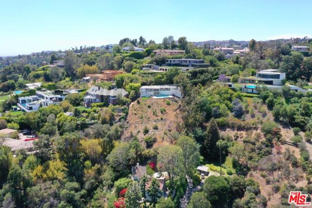 948 Bel Air Road Los Angeles, California Nestled on one of the prime streets in Bel-Air with explosive city and canyon views, 948 Bel Air provides an opportunity to build a 17,000-SF geometric modern architectural masterpiece designed by SAOTA, a world-renowned architecture firm. A wellness-conscious entertaining compound made of beautiful wood and stone that completely harmonizes with its natural surroundings, with a green wood house on its top and exterior walls covered with greenery. A grand hallway entry leads to interiors with visually stimulating open floor plan and openings on the ceilings that foster circadian rhythm with natural light, fresh air, and the sweeping views. The great room, study and kitchen with breakfast bar, formal and alfresco dining areas all extend outward with terraces that maximize the enjoyment of the outdoor. The entertainment lounge features a media wall, bar and wine cellar and opens to a well landscaped lawn with an expansive pool and a fireside lounge and dining. Perfect entertaining flow continues to the lower-level outdoor guest lounge, lush basement lawn, theater, and gym. Primary suite is a resort-like retreat with an oversized pristine garden. Once in a lifetime development opportunity with plans destined for significance.