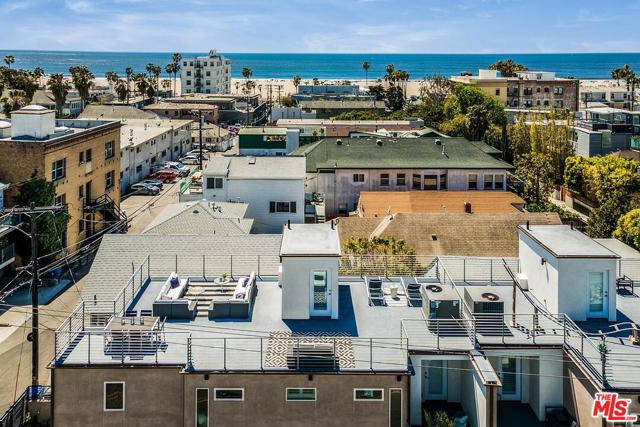 62 Ozone Avenue Venice, California Set just steps from the sand in Venice with spectacular ocean views, this multi-level home pairs spacious, sunlit interiors with upscale finishes for an elevated take on casual coastal living. The main level features an open-concept layout with rich wood floors, flowing seamlessly among the great room, dining area and gourmet chef's kitchen, replete with high-end stainless steel appliances and natural stone countertops, and outbound via glass sliding doors to a large balcony. The home features three bedrooms with two being en suite, including the generous primary suite with ample closet space and a luxe spa bath with an oversized shower. On the lower level, find a flexible living space and full bath that opens to the enclosed grassy yard, and on the private rooftop, discover an expansive lounge space set to coveted ocean vistas perfect for sunset entertaining and sun-drenched relaxation. Moments from Abbot Kinney, Rose Avenue, Main Street and the beach, this home is a true coastal oasis that can't be found elsewhere in Venice.