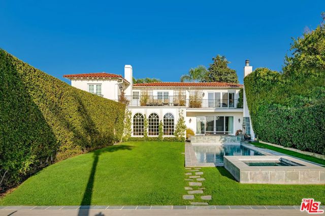 719 S Beverly Glen Boulevard Los Angeles, California Cradled by lush hedges and safeguarded by a private gate, this completely remodeled, magnificent villa offers unrivaled canyon & city views with a resort-quality garden & guest house that promise the utmost privacy, comfort, and entertainment near Century City Mall, Warner School & Holmby Park. Designed by world-renowned Sam Schatz to embody styles and functionalities of the highest standards. Striking chandelier entry takes you to a flowing indoor/outdoor space crafted with the finest wood, stone & marble such as African Mahogany & Brazilian Quartzite. Impenetrable and earthquake proof with 18mm woven steel framing. Timeless wooden sitting room & kitchen with marble countertops are perfect for entertaining of any scale. Lavish primary suite boasts generous office & soothing bathtub with irresistible views. Expansive terrace overlooking trophy vistas wraps around the entire upper level. Every day is a Roman holiday in your well-landscaped garden with a heated pool/spa, stone fireplace & outdoor dining & completed with exquisitely updated hardscape and bluestones. A vaulted-ceiling guest cabin with a sundeck boasts a gym & yoga studio with beautiful Pennsylvania blue stone & bamboo floors throughout, making you an unforgettable host. A property like this rarely lingers in the market. Seize this perfect home to put down roots.