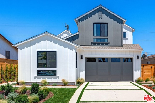 752 Hartzell Street Pacific Palisades, California Built by Thomas James Homes, this brand new home has been professionally designed, handcrafted to fit your needs, and comes with a full 10 year new home construction warranty. The first floor of this 5 bed, 6 bath Pacific Palisades farmhouse boasts a formal dining, private guest suite with separate living area, first-floor bedroom with en suite bath, and powder bath. The inviting great room with fireplace is overlooked by a chef's kitchen, which features a nook for casual dining, an island with bar seating, butlers pantry with built-in desk, and a walk-in pantry. Sliding doors welcome you out into the backyard with patio and BBQ for outdoor entertaining. Ascend the stairs to the spacious loft, which includes a built-in and separate tech space with built-in desk. Two additional secondary bedrooms, each with en suite bath and walk-in closet, are accompanied by a laundry room with sink and plentiful storage. The grand suite features a T&G ceiling and luxurious spa-like bath, including dual vanities, a freestanding soaking tub, walk-in shower, and dual custom walk-in closets.