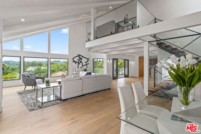 9645 HIGHRIDGE Drive Beverly Hills, California This newly renovated contemporary Beverly Hills estate astonishes w/ breathtaking mountain vistas, soaring ceilings, and light wood & marble finishes throughout rounding off this prestigious home. A grand entry establishes the luxurious aesthetic w/ modern open floor plan, allowing for a seamless flow through the living, dining, and kitchen areas. Beautiful soaring windows, & sliding glass doors throughout give it its bright & serene indoor/outdoor feel. Cook w/ poise in the sleek chefs kitchen w/ marble accents and elegant center island, grand farmhouse style sink, and top-of-the line appliances. Unwind in the master suite boasting a vaulted ceiling, & private balcony overlooking the lush views. A polished feel throughout, the decadent bath features an expansive glass shower, tranquil soaker tub & dual vanity sink. Amenities include spacious loft, extensive balconies, cozy fireplaces, well-appointed guest rooms & lavish baths! Soak up California living in this heavenly estate!