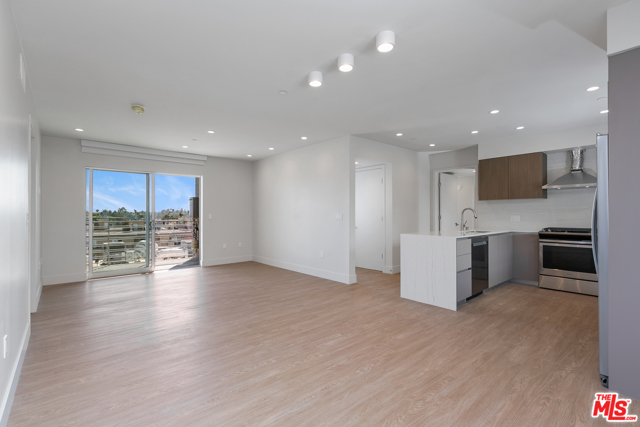 11837 Mayfield Avenue 405 Los Angeles, California Welcome to Reve, a bespoke collection of new residences in Brentwood. Reve delivers impeccably designed living spaces that inspire harmony in a modern home, a place for restorative respite and spectacular sunsets. Residence 405 is beautifully laid out, with a U-shaped kitchen with plenty of pantry space, great for cooking and entertaining. The living room is spacious and has a balcony to act as an extension of the living space. The kitchen has stainless steel appliances, In-unit LG washer/dryer, hardwood composite flooring throughout, and pental quartz counters in the kitchen and bathrooms. This residence is facing West with amazing views on higher level units. This E1 floor plan is available between $6800 to $7550 depending on floor level. Includes parking for 2 vehicles. Rooftop lounge, courtyard zen garden, and fitness center on site. More photos to come as we complete construction, as we are projected to open this Fall!